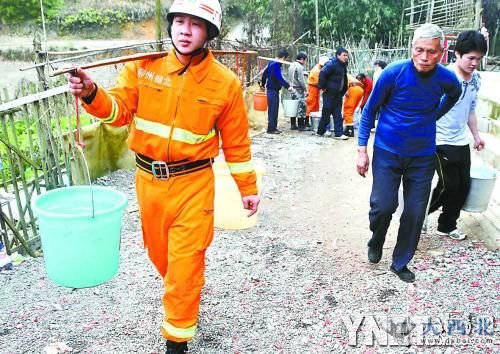 柳北區(qū)長塘鎮(zhèn)西流村浪江屯已暫停從柳江取水，消防隊(duì)員幫村民挑水